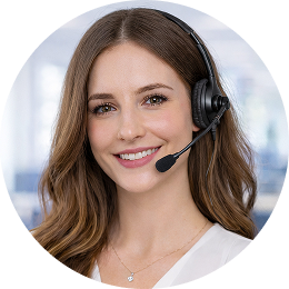 A woman with long brown hair, wearing a headset with a microphone, smiles at the camera. She is dressed in a light-colored top and appears to be in an office environment.